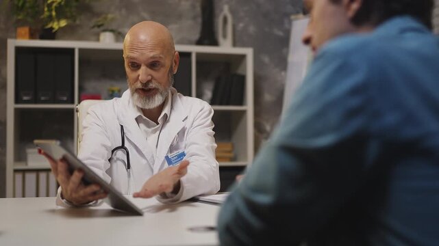 General practitioner informs male patient of good health check-up results
