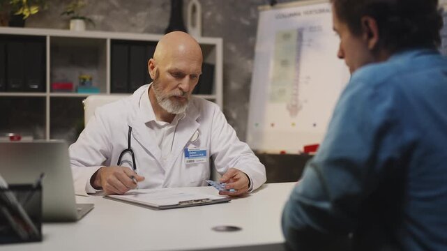 Urologist prescribes medication to male patient in clinic, men's health issues