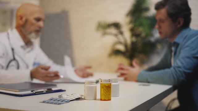 Doctor and male patient discuss treatment plan and medication during check-up