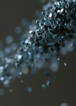 Close-up of a cluster of small, metallic objects. the objects appear to be small, square-shaped, and have a metallic sheen.