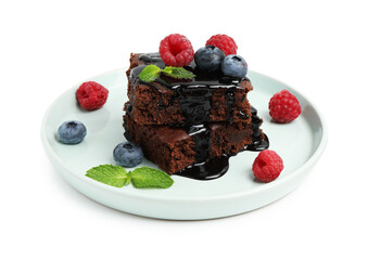 Naklejka na ściany i meble Pieces of delicious brownie with fresh berries, chocolate topping and mint isolated on white