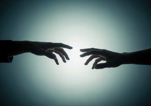 Silhouettes of two hands reaching towards each other