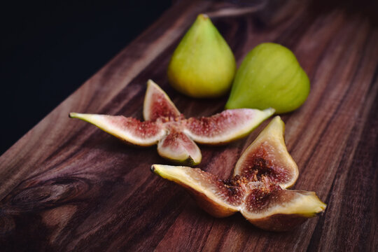 Closeup of fresh green figs sliced served on a charcuterie board
