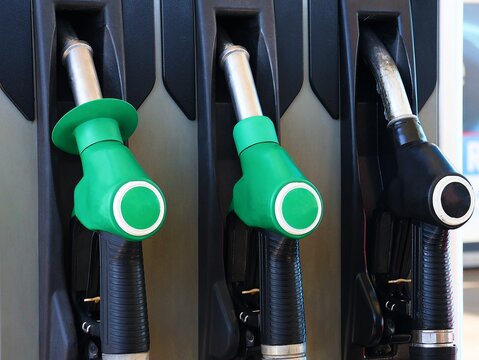 Close-up of fuel nozzles at a gas station.