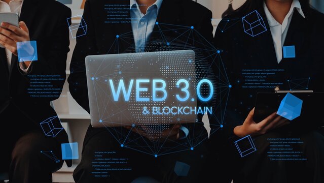 Business professionals discussing Web 3.0 concepts with a laptop displaying blockchain technology term amidst digital graphics and icons. Entropy.