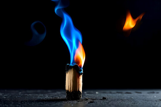 Macro shot of a bright blue and orange flame burning on a wooden matchstick against a dark background. Concept of intense heat, energy, and ignition.
