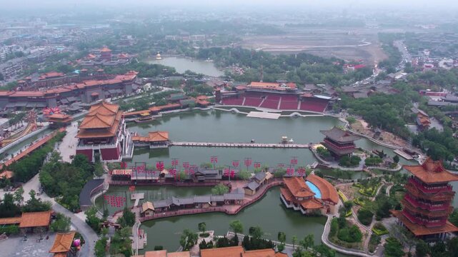 Aerial shot of a traditional Chinese architectural complex with water features and landscaped surroundings.
