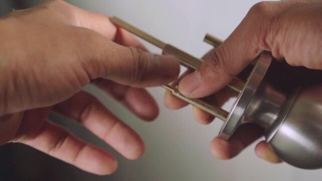 Close up of hands assembling door knob mechanism