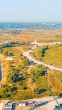 Vertical video. Murom, Russia. Construction of a bridge across the Oka River. Highway M-12 Moscow-Nizhny-Novgorod-Kazan. Drone footage. Rich colors