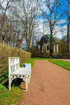 White bench sits beside gravel path