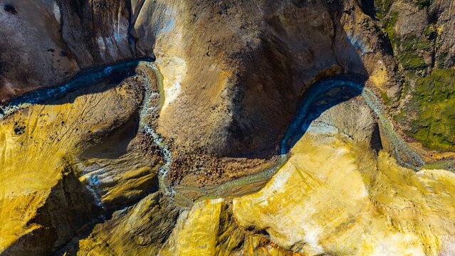 Aerial view of the colorful rhyolite mountains and winding geothermal river in the Kerlingarfjoll mountain range in Hrunamannahreppur, Iceland.