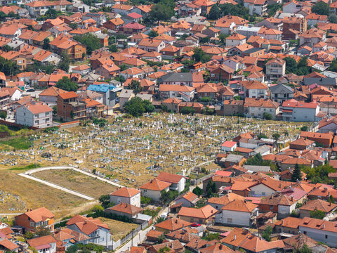 Aerial view of the historic cemetery nestled among dense residential houses with terracotta rooftops in Prilep, Prilep Municipality, North Macedonia.
