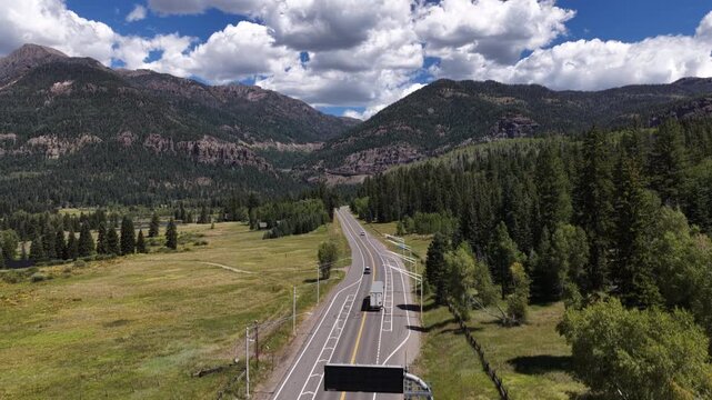 Aerial of US highway 160 on Wolf Creek Pass in southern Colorado in summer with semi truck in San Juan Mountains