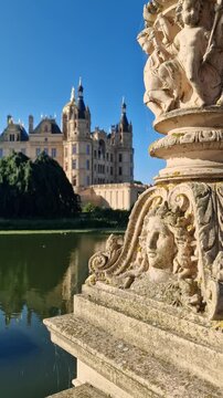 Vertical view of ornate stonework at Schwerin Castle waterfront