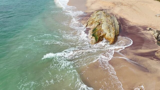 Aerial view of Silent Beach in Sri Lanka, featuring a secluded sandy coastline, turquoise ocean water, tropical vegetation and an untouched paradise-like landscape, 4k.