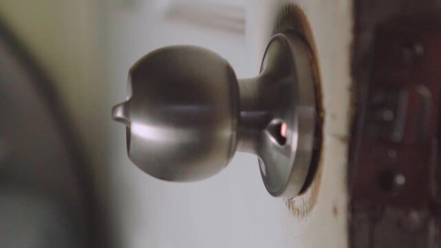Worker repairing and replacing a broken door knob