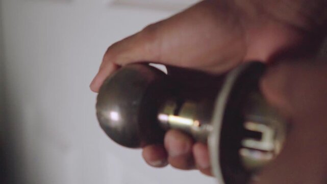 Handyman disassembling an old doorknob mechanism
