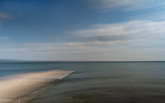 Intention movement of a wavey lake and blue sky with clouds creating a dreamy look

