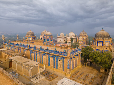 Aerial view of the historic tombs of royal families near Derawar Fort, featuring blue tile work, domed architecture, and desert landscape in Derawar, Punjab, Pakistan.