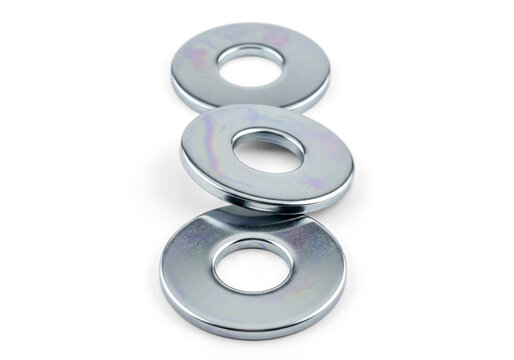 Three shiny metal washers for construction and hardware