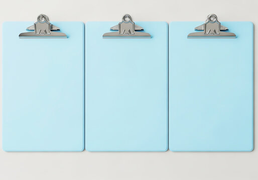 Three light blue clipboards lined up for office work