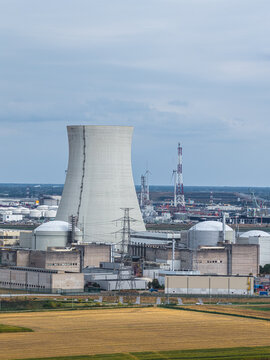 Aerial view of Doel Nuclear Power Station featuring its iconic cooling tower, reactor buildings, and surrounding industrial infrastructure in Beveren-Kruibeke-Zwijndrecht, Vlaanderen, Belgium.