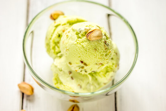 organic homemade ice cream in glass bowl on wooden background