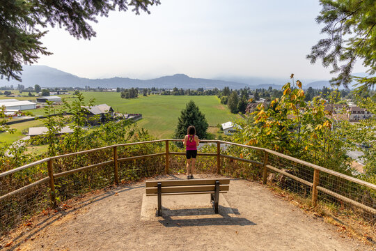 Woman Overlooking Green Valley From Little Mountain Stairs Overlook in Chilliwack BC Canada