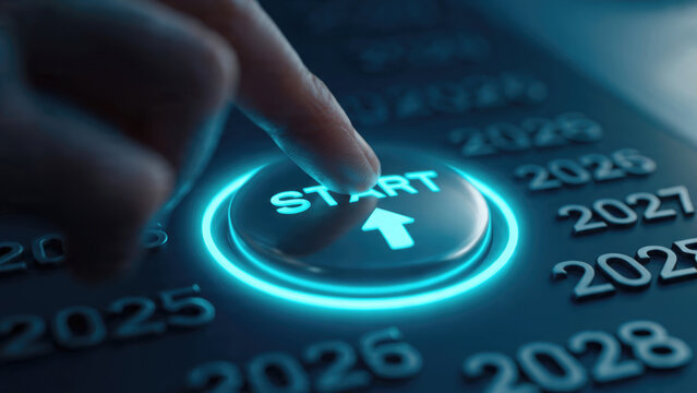 Finger pressing start button with glowing blue light and blurred years in the background