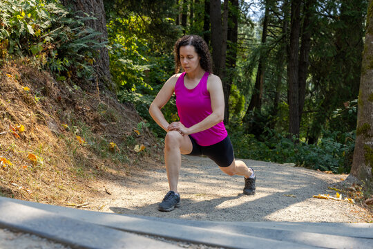 Woman Stretching Lunge Exercise Outdoors On Little Mountain Stairs In Chilliwack BC Canada