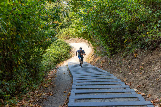 Male Runner Sprinting Up Little Mountain Stairs on Forest Trail in Chilliwack BC Canada for Fitness
