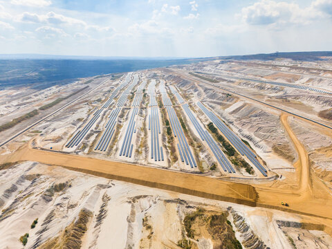 Aerial view of Hambach open pit mine featuring rows of photovoltaic solar panels installed on reclaimed land for renewable energy generation in Elsdorf, North Rhine-Westphalia, Germany.