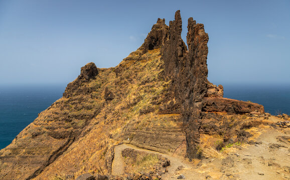 Aerial view of rugged volcanic rock formations of Fontainhas in Santo Antao with steep cliffs and dry vegetation overlooking the Atlantic Ocean in Ponta do Sol, Ribeira Grande, Cabo Verde.