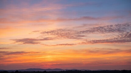 Fototapeta premium Stunning golden sunset sky with soft clouds, natural evening twilight background