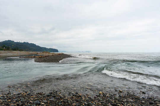 Black Sea waves with city skyline on the horizon in Poti, Georgia