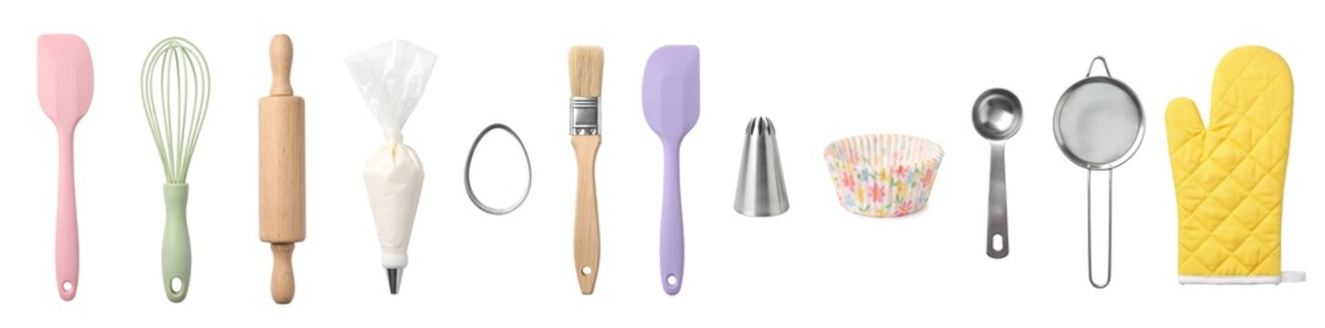 Baking tools for Easter are arranged on a white surface. The set includes a whisk, rolling pin, spatula, and more. These tools help make treats for the holiday