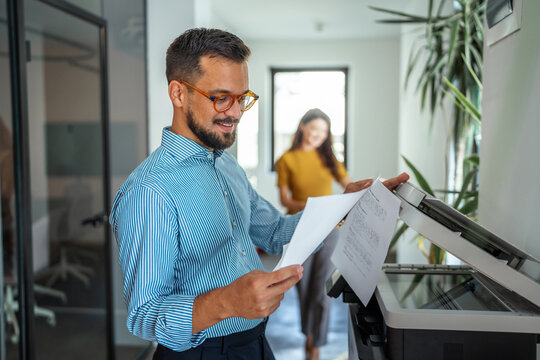 Business man preparing documents on office printer