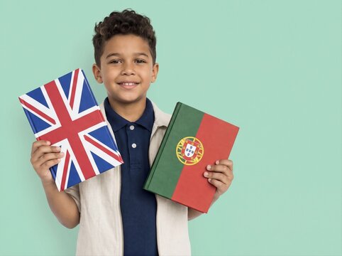 Smiling Brazil boy holding British and Portuguese flag books on green background. School education and language learning concept. Studio portrait for international education campaign