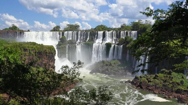 Powerful multi-tiered cascades of the Iguazu Falls in South America, flowing into a misty gorge. A breathtaking landscape of the jungle wilderness
