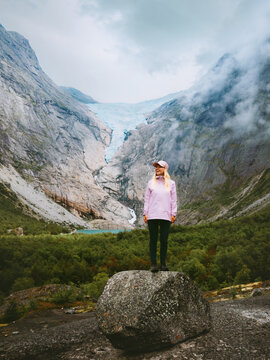 Woman travel solo in Norway sightseeing Briksdalsbreen glacier view female tourist hiking in mountains active summer vacations healthy lifestyle tour explore Stryn, freedom candid emotion coolcation