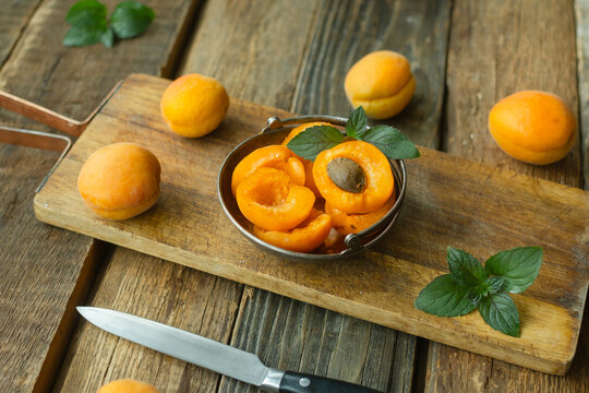 Fresh apricots on wooden background. Summer seasonal fruits.
