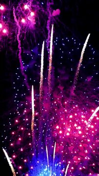 Vibrant fireworks exploding in the night sky with bright colorful sparks and smoke trails, perfect for New Year's Eve, Fourth of July, holiday celebrations, festival backgrounds, and event design.