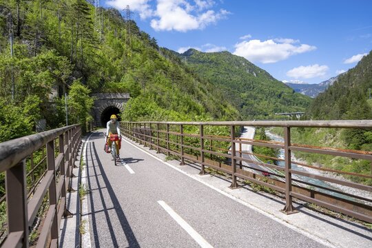 Cyclists with panniers on a cycle path, cycle path along the old Pontebba railway line in the Canal Valley, Alpe-Adria cycle path, bike packing, Friuli-Venezia Giulia, Italy