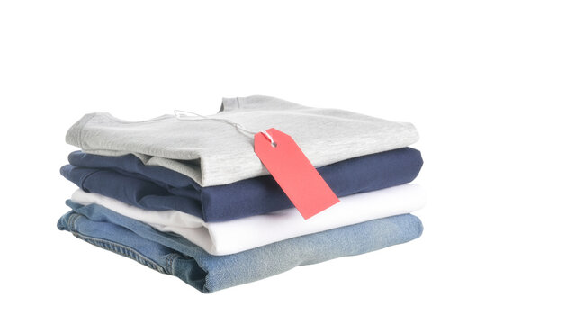 Folded clothing stack with red price tag, neat pile of cotton shirts and denim jeans for retail isolated PNG with Transparent Background