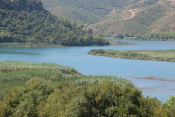 Fototapeta premium Scenic River Lake Landscape with Green Hills for Hiking Camping Tourism and Boating