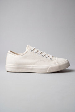 White canvas sneakers on a gray background