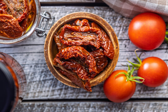 Sun-Dried Tomatoes in Olive Oil in a Rustic Bowl With Fresh Tomatoes and Preserved Jars
