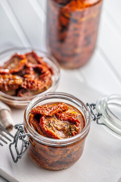 Sun-Dried Tomatoes in Glass Jar Preserved in Olive Oil for Gourmet Mediterranean Cooking