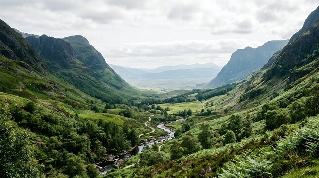 Breathtaking Landscape of a Verdant Highland Valley Featuring a Winding River and Rugged Mountain Peaks