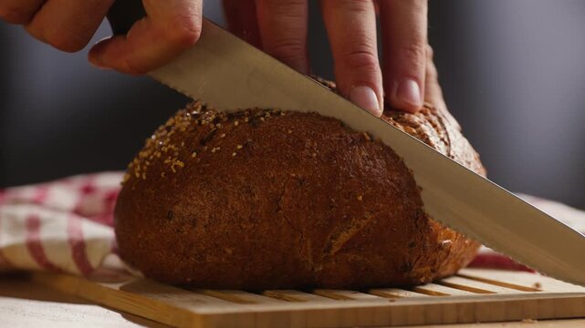 Bread multigrain loaf held in hands, whole wheat seeded crust with millet and seeds, close-up macro shot